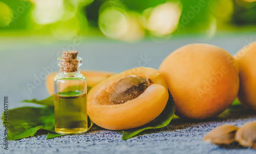 Tableau sur toile Apricot kernel oil in a small bottle. Selective focus.