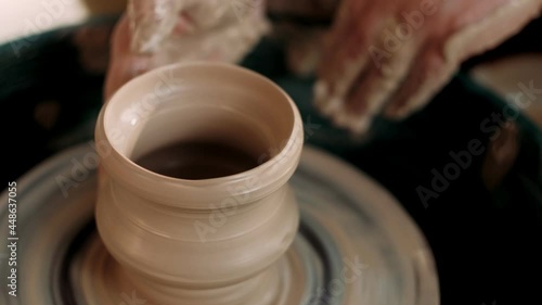 Working process at potters wheel in art studio. Potter creates jug.  Small business, talent, invention, inspiration, hobby. reativity and traditional crafts concept.
 photo