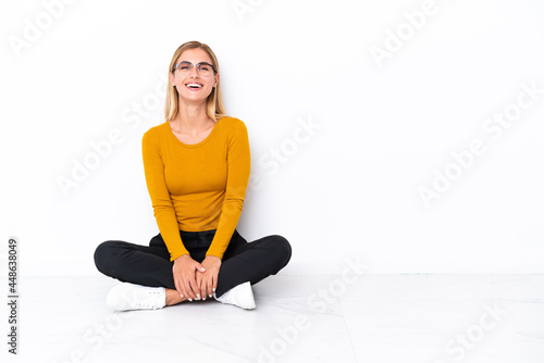 Принти на полотні Blonde Uruguayan girl sitting on the floor laughing