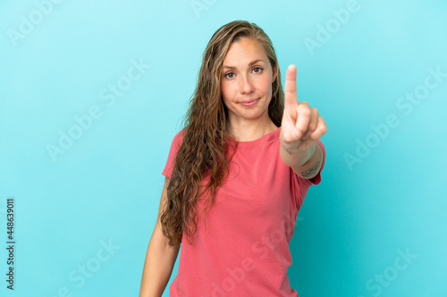 Young caucasian woman isolated on blue background showing and lifting a finger