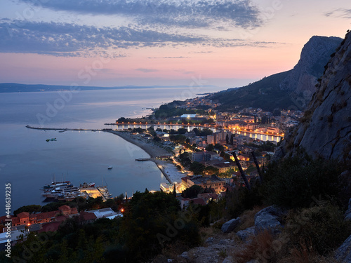 City of Omis by night. Evening panorama of the Croatian seaside resort. Blue hour.