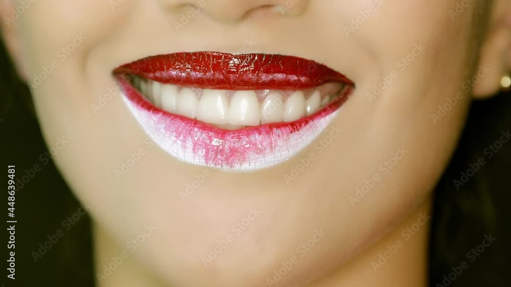 Closeup of a beautiful woman lips with beautiful red and white makeup sending air kiss . Close up of girl's mouth having flirty emotions and sending air kiss . Closeup of a beautiful woman lips with beautiful red and white makeup sending air kiss . Close up of girl's mouth having flirty emotions and sending air kiss .