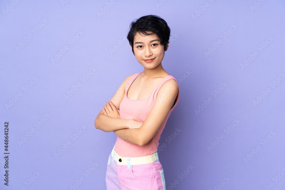 Young Vietnamese woman with short hair over isolated purple background with arms crossed and looking forward Young Vietnamese woman with short hair over isolated purple background with arms crossed and looking forward