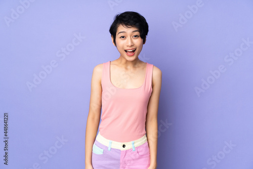 Young Vietnamese woman with short hair over isolated purple background with surprise facial expression