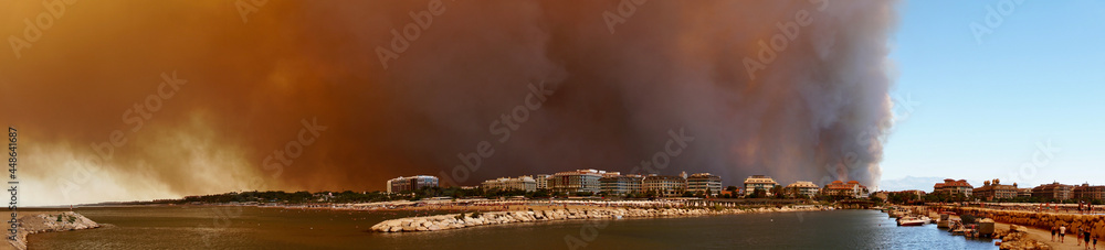 ANTALYA-MANAVGAT-SIDE, TURKEY - AUGUST 02, 2021: The forest fire that started in Manavgat threatens settlements and tourism facilities. Yellow smoke covered the place of the blue sky and sea. ANTALYA-MANAVGAT-SIDE, TURKEY - AUGUST 02, 2021: The forest fire that started in Manavgat threatens settlements and tourism facilities. Yellow smoke covered the place of the blue sky and sea.
