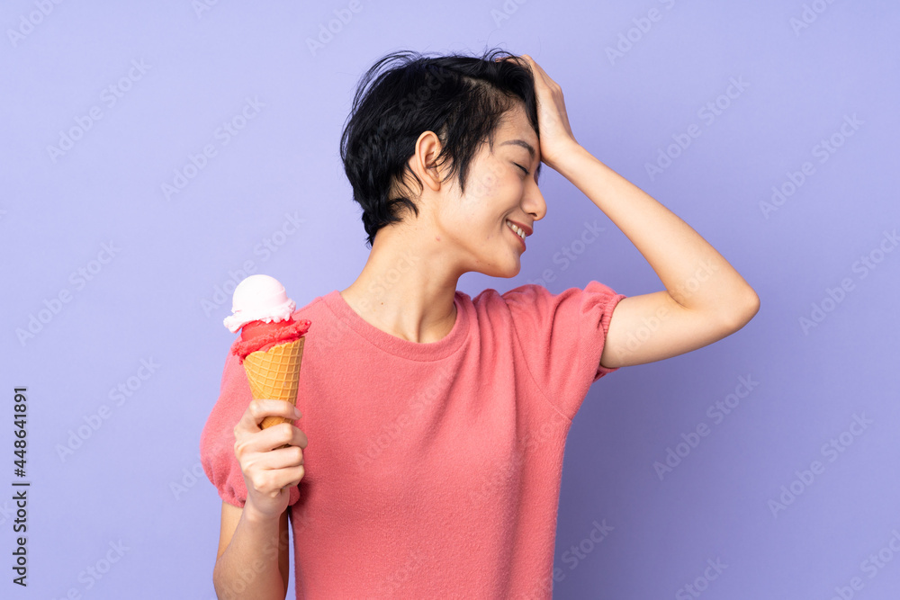 Young Vietnamese woman with short hair holding a cornet ice cream over isolated purple background has realized something and intending the solution Young Vietnamese woman with short hair holding a cornet ice cream over isolated purple background has realized something and intending the solution