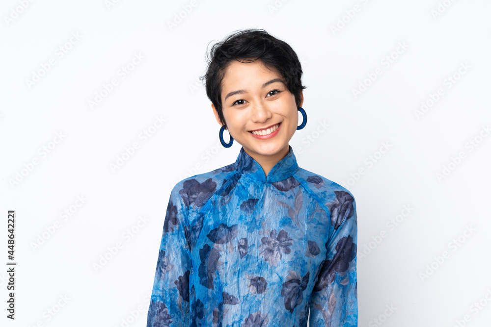 Young Vietnamese woman with short hair wearing a traditional dress over isolated white background Young Vietnamese woman with short hair wearing a traditional dress over isolated white background