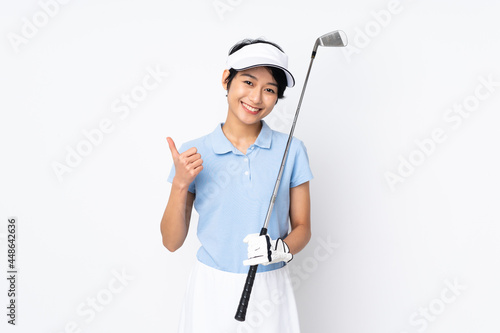 Young Vietnamese golfer woman over isolated white wall with thumbs up because something good has happened