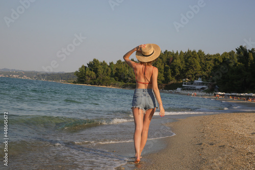 Tourist woman enjoying idyllic day at the beach.