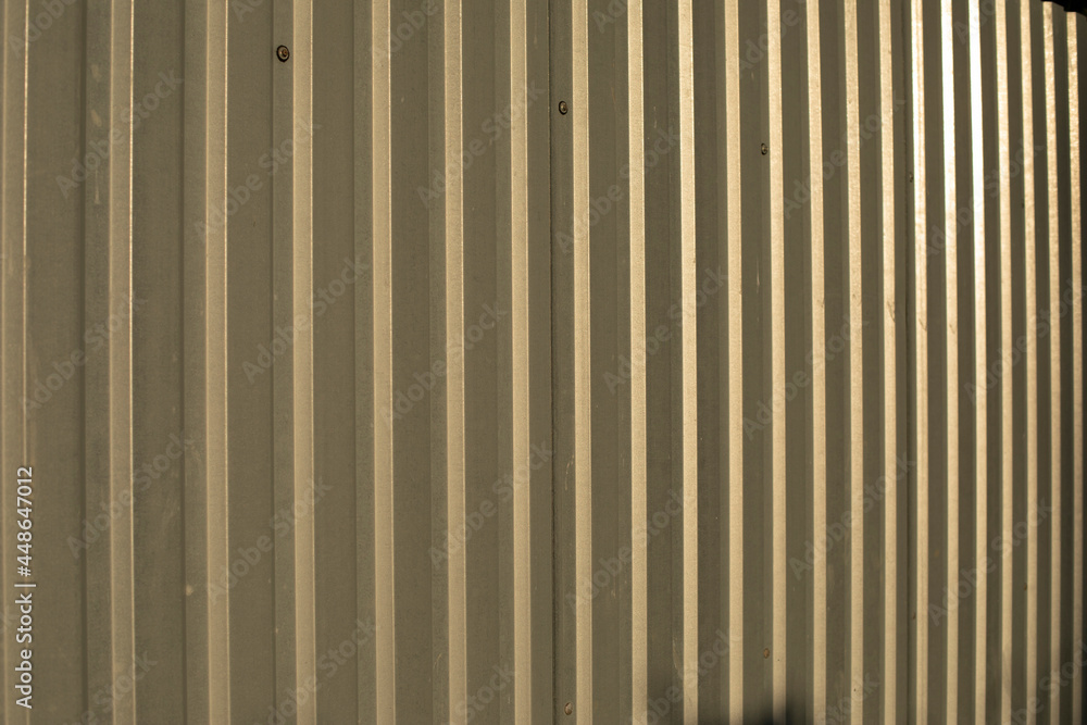 The texture of the metal fence. Stainless steel in sunlight. The texture of the metal fence. Stainless steel in sunlight.