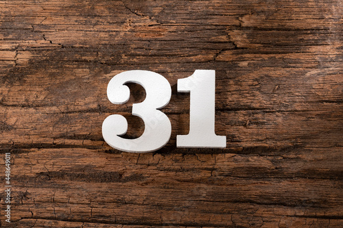 Number thirty one 31 - White Piece on Rustic Wood Background