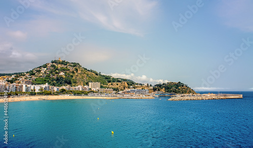 Tourists enjoy at the beach in Blanes in Costa Brava in a beautiful summer day, Spain