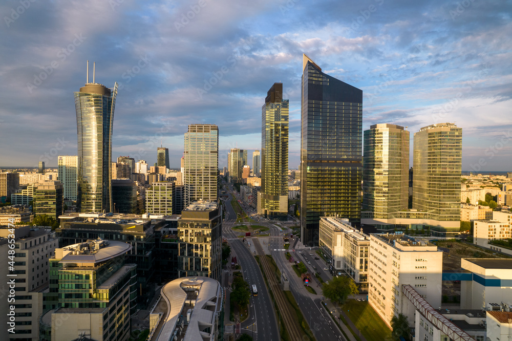 Fototapeta premium Warsaw at sunset. The capital of Poland is illuminated by a beautiful orange sun.