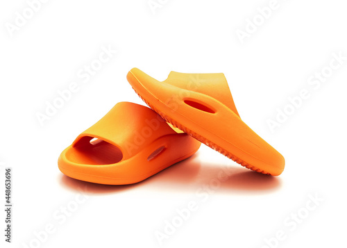 Cute pair of orange pillow slide sandals for toddler non-slip foam slippers isolated on white