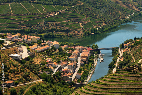 Scenic view of the beautiful Pinhão village surounded by vineyards in the beautiful Douro river valley, Vila Real district, Viseu district, Portugal photo