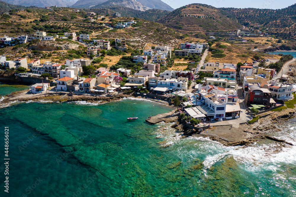 Aerial view of the Cretan village of Mochlos surrounded by crystal clear blue waters