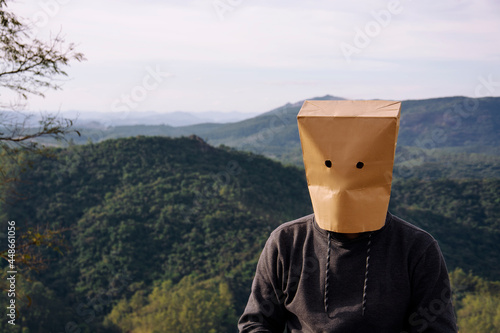 man with paper bag on his head outdoors