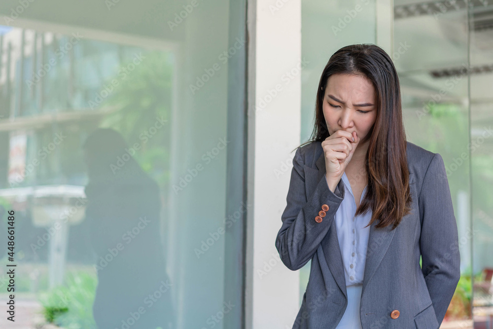 Working woman concept a working woman coughing after contacting with many people while working without any protection Working woman concept a working woman coughing after contacting with many people while working without any protection