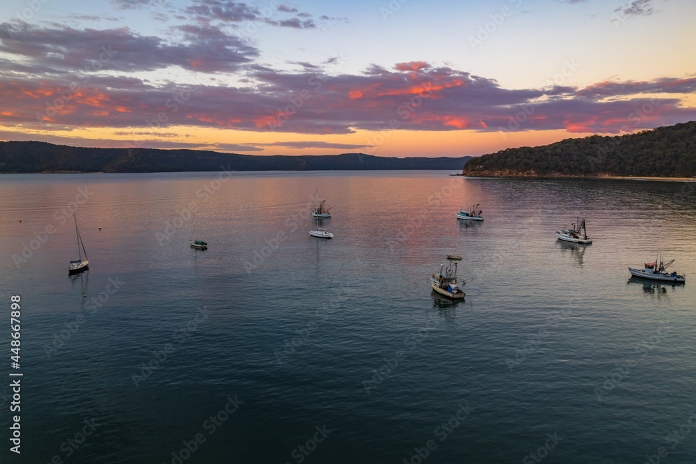 Fototapeta premium Peaceful sunrise over the bay with boats