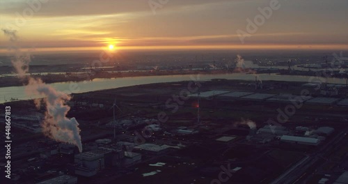 Industrial fumes on a port at sunrise photo