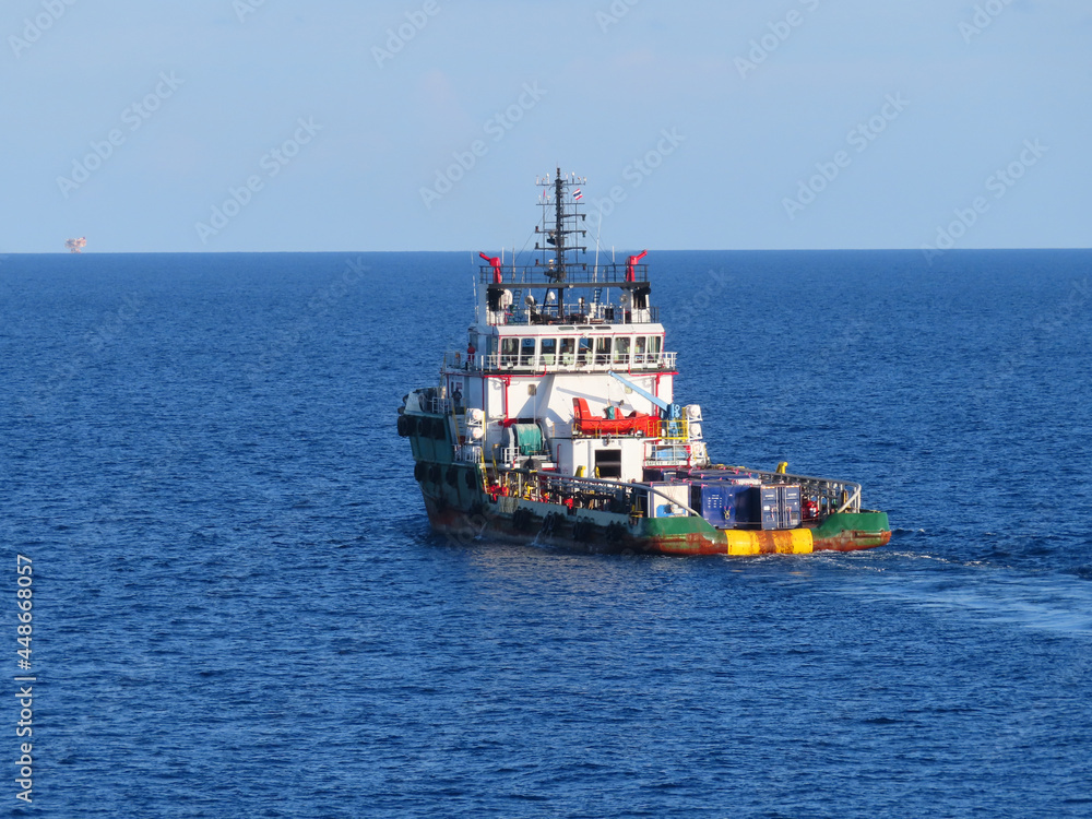 Supply boat transfer cargo to oil and gas industry and moving cargo from the boat to the platform. Boat is waiting transfer cargo and crews to platform. Supply boat transfer cargo to oil and gas industry and moving cargo from the boat to the platform. Boat is waiting transfer cargo and crews to platform.