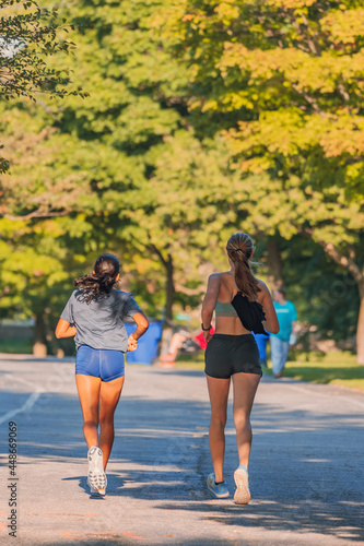 two women running on the road 