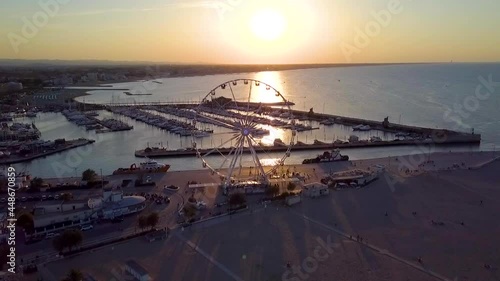 Scenic View Of Ferris Wheel Near Shoreline Beach Of Rimini, Italy At Sunset. - Aerial Shot photo