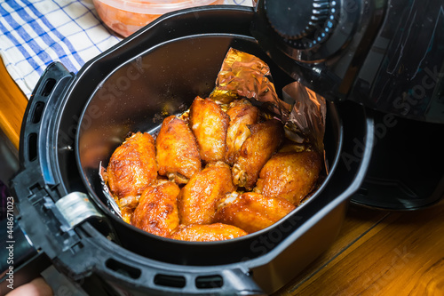 Frying BBQ chicken wings in a hot air fryer.