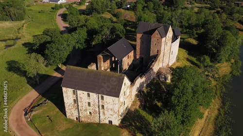 Aerial view around the Kastelholm castle, sunny evening in Aland, Finland - high angle, circling shot photo