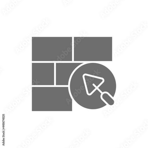 Brick wall with putty knife, repair bricklaying, construction grey icon.