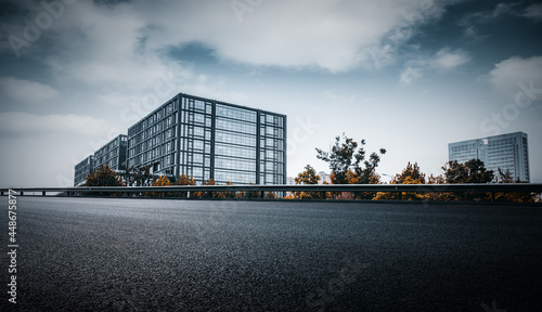 Highway passing by the glass curtain wall of high-rise buildings in the urban business district