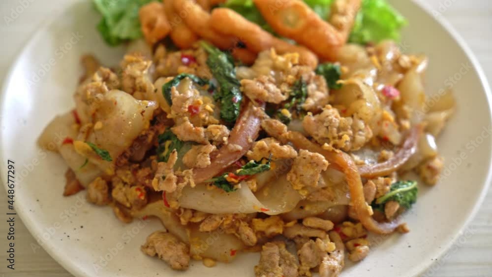Stir-fried noodle with minced chicken and basil - Asian food style Stir-fried noodle with minced chicken and basil - Asian food style