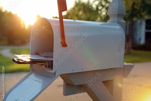 open mail box with a pile of letters and newspapers photo