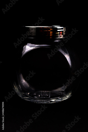 Unique elegant transparent bottle in black background in HD size