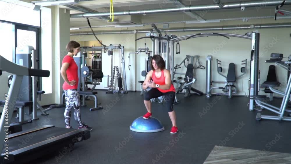 Two attractive caucasian girl train in the gym. Slow-motion shot. Two attractive caucasian girl train in the gym. Slow-motion shot.