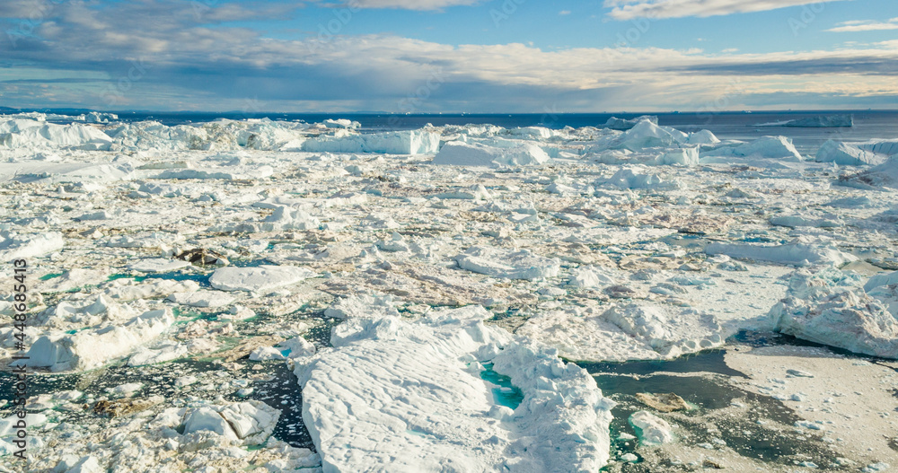Fototapeta premium Climate Change. Iceberg rom glacier in arctic nature landscape on Greenland. Icebergs in Ilulissat icefjord. Melting of glaciers and the Greenland ice sheet is a cause of sea levels rise