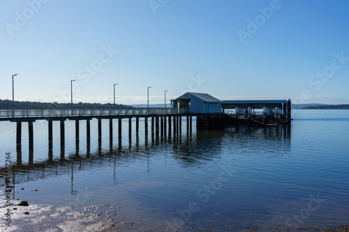 Morning view from the shoreline, to the Victoria Point jetty, reflected in the calm water of Moreton Bay  © Silky Oaks