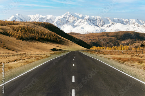 Road to mountains in autumn time. The concept of active and automobile tourism.