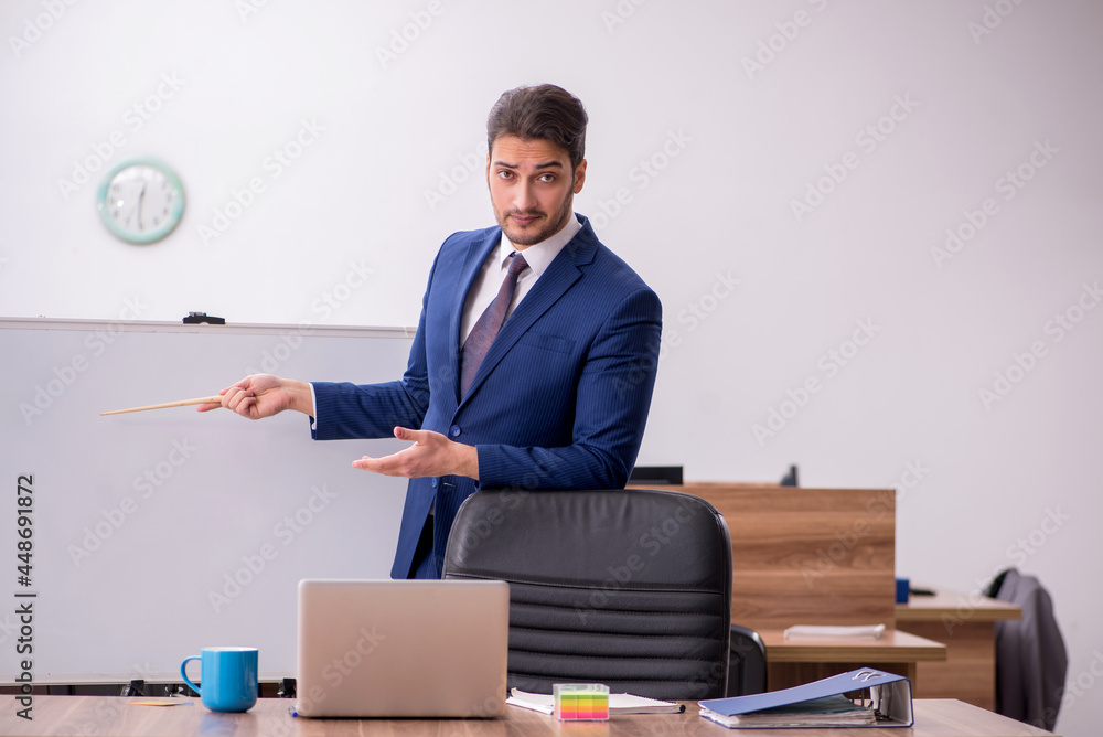 Young handsome employer in teleconference concept Young handsome employer in teleconference concept