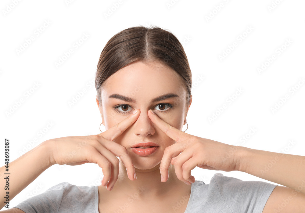 Beautiful young woman doing facial yoga on white background Beautiful young woman doing facial yoga on white background