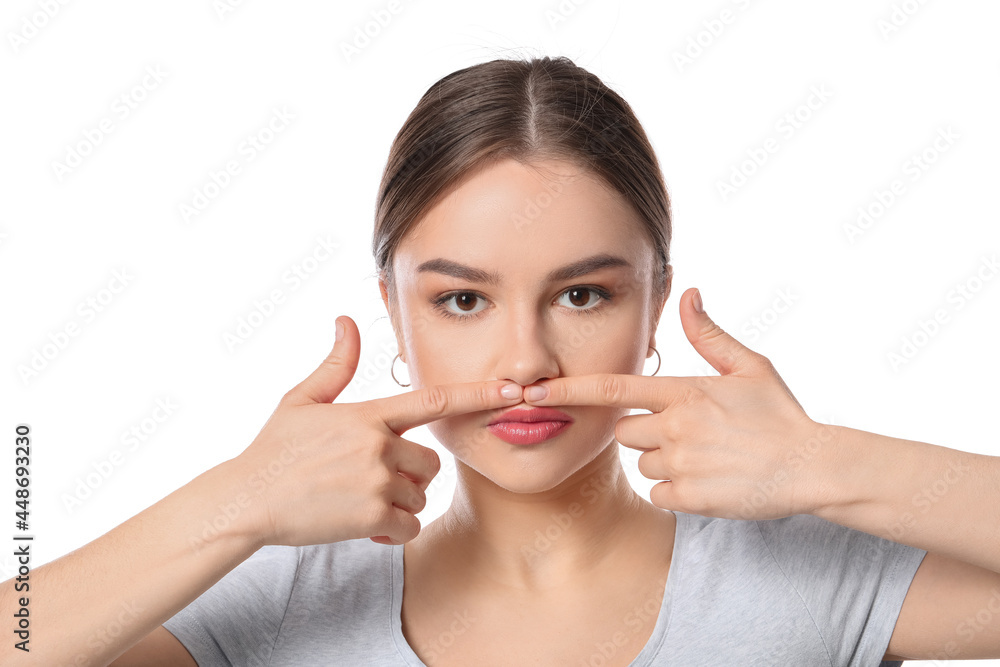 Beautiful young woman doing facial yoga on white background Beautiful young woman doing facial yoga on white background