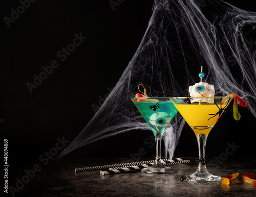 Canvas Print Scary colorful Halloween cocktails with party decorations on dark background wit