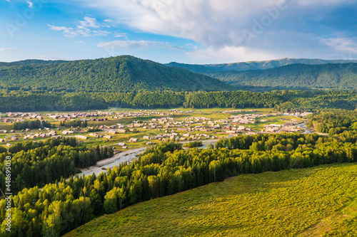 Beautiful Hemu Village with natural scenery in Xinjiang green mountain and forest with rivers.Hemu Village is a famous travel destination in China.Aerial view.