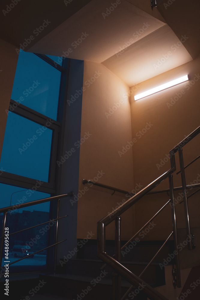 Fototapeta premium Atmospheric staircase at night with a dim Atmospheric