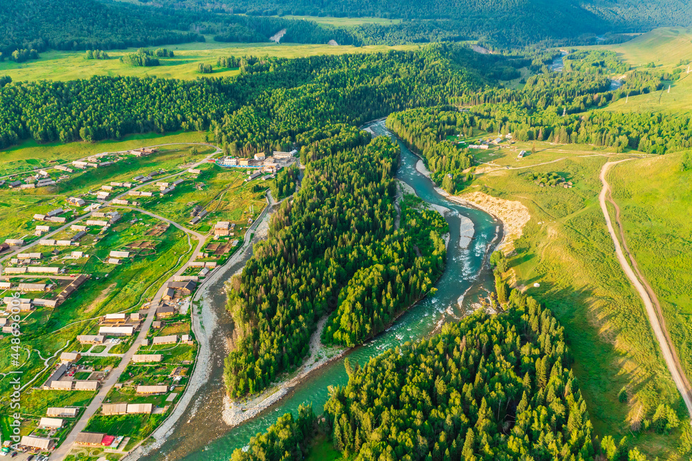 Beautiful Hemu Village with natural scenery in Xinjiang,green forest and river.Hemu Village is a famous travel destination in China.Aerial view.