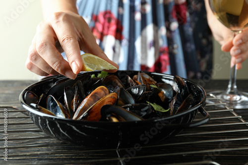 Concept of delicious food with mussels on wooden table