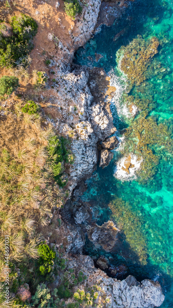 Turquoise emerald water of the Mediterranean Sea.Amazing aerial view of calm seaside.Rocky seashore top view.Holiday travel background copy space.Relax beach vacation luxury summer scene