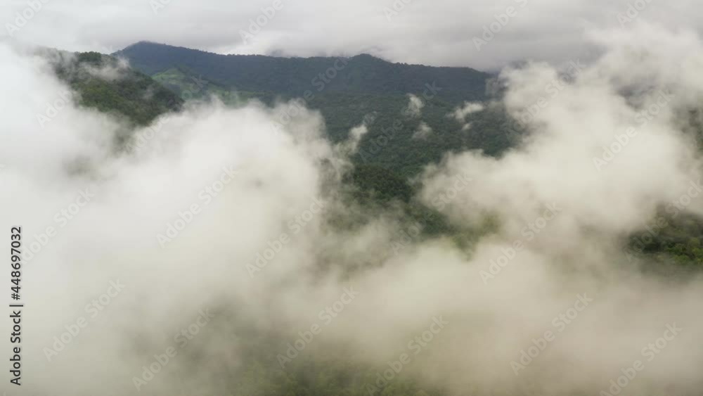Aerial view flying above lush green tropical rain forest mountain with rain cloud cover during the rainy season on the Doi Phuka Mountain reserve national park. In, the northern Thailand Aerial view flying above lush green tropical rain forest mountain with rain cloud cover during the rainy season on the Doi Phuka Mountain reserve national park. In, the northern Thailand