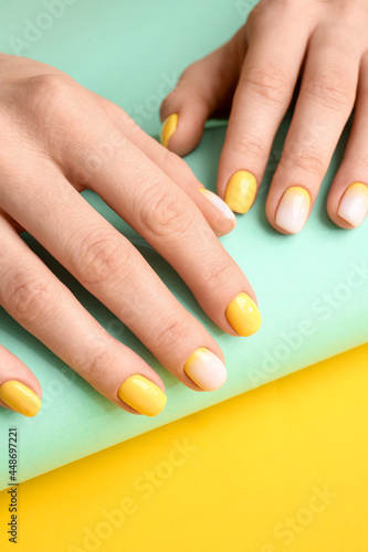 Female hands with beautiful manicure on color background  closeup