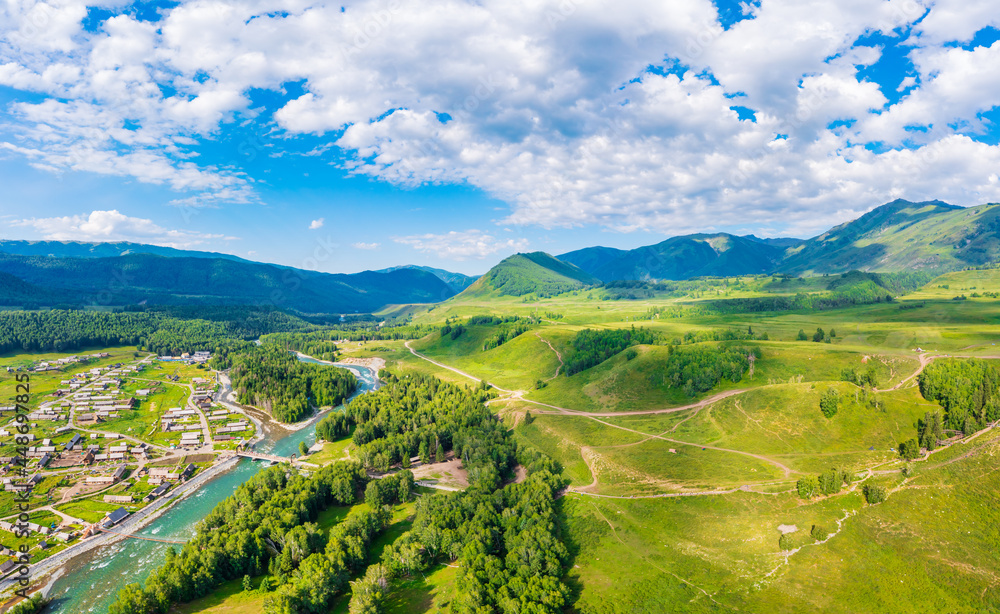 Fototapeta premium Beautiful Hemu Village with natural scenery in Xinjiang,green mountain and forest with rivers.Hemu Village is a famous travel destination in China.Aerial view.